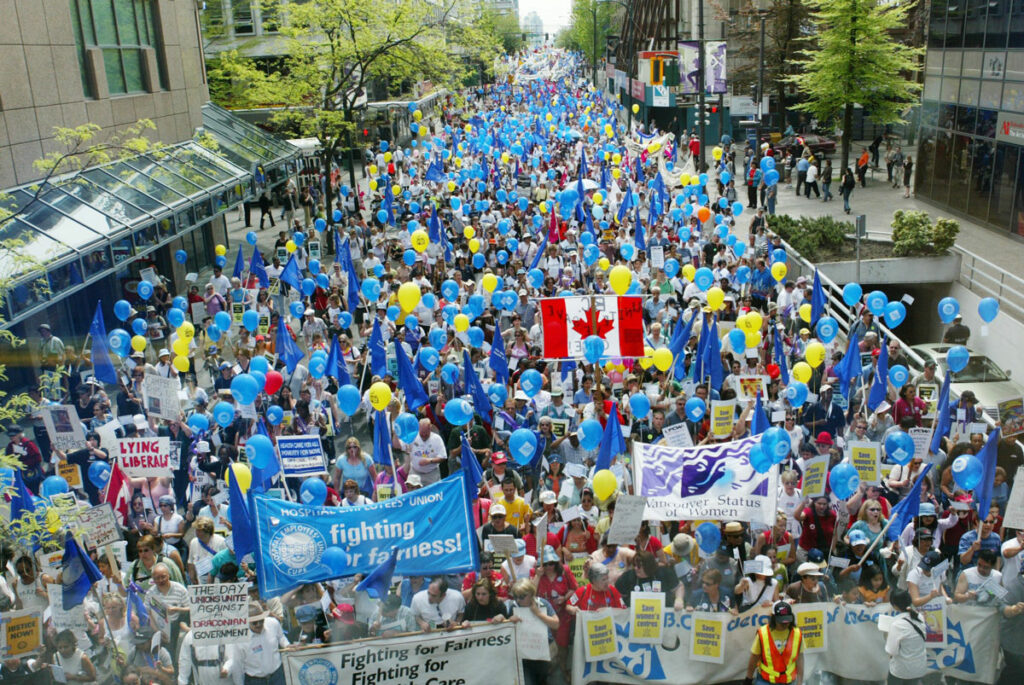 A huge crowd turned out for the May 1, 2004 May Day Rally, holding blue balloons and banners in support of the HEU.