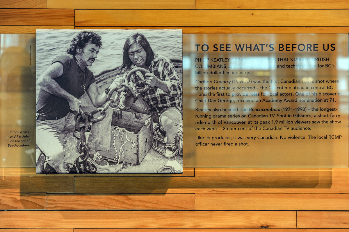 The plaque reads: Philip Keatley created a TV series that starred British Columbians and formed the talent and technical base for BC's billion-dollar film industry. Caribou Country (1959–67) was the first Canadian series shot where the stories actually occurred — the Chilcotin Plateau in central BC — and the first to provide roles for local actors. One of his discoveries, Chief Dan George, received an Academy Award nomination at 71. Keatley also helmed The Beachcombers (1971–1990), the longest-running drama series on Canadian TV. Shot in Gibson’s, a short ferry ride north of Vancouver, at its peak, 1.9 million viewers saw the show each week — 25% of the Canadian TV audience. Like its producer, it was very Canadian. No violence. The local RCMP officer never fired a shot.