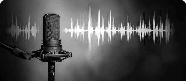 Black and white photo of a microphone and a sound graph behind