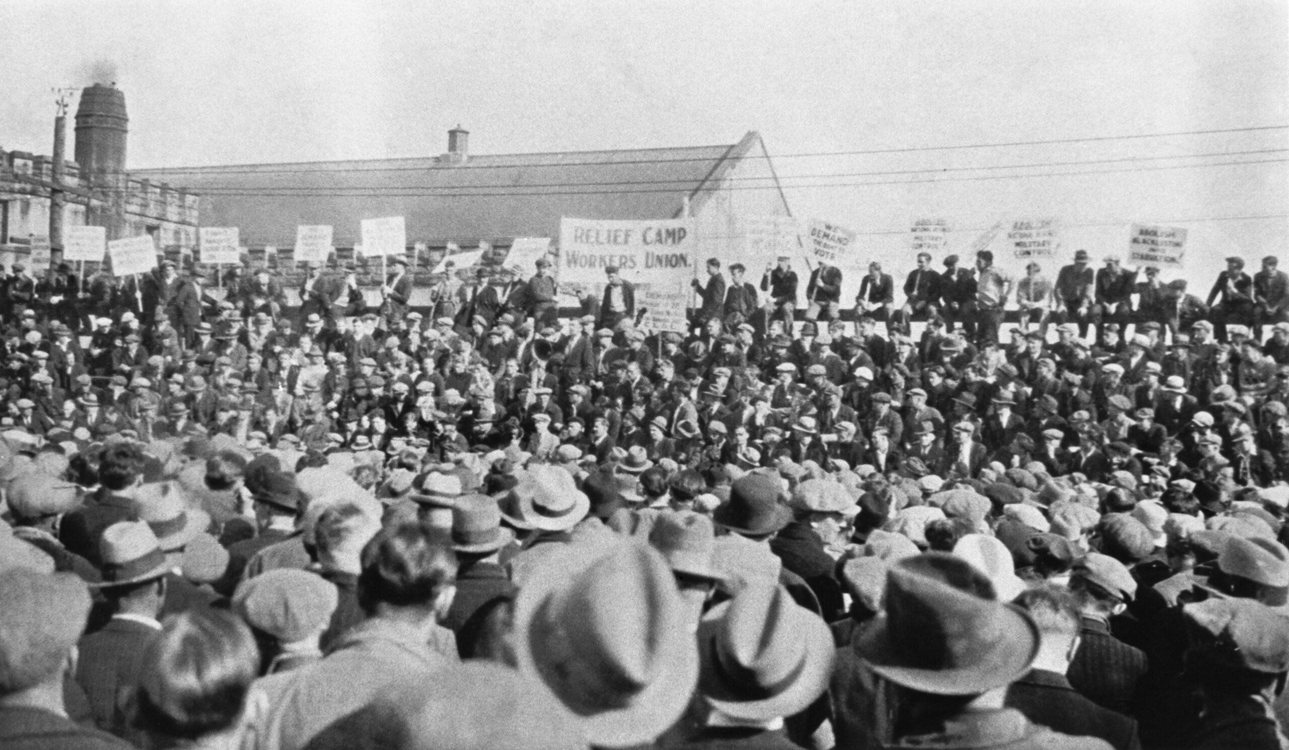 Black and white photo of a huge rally at a labour camp.