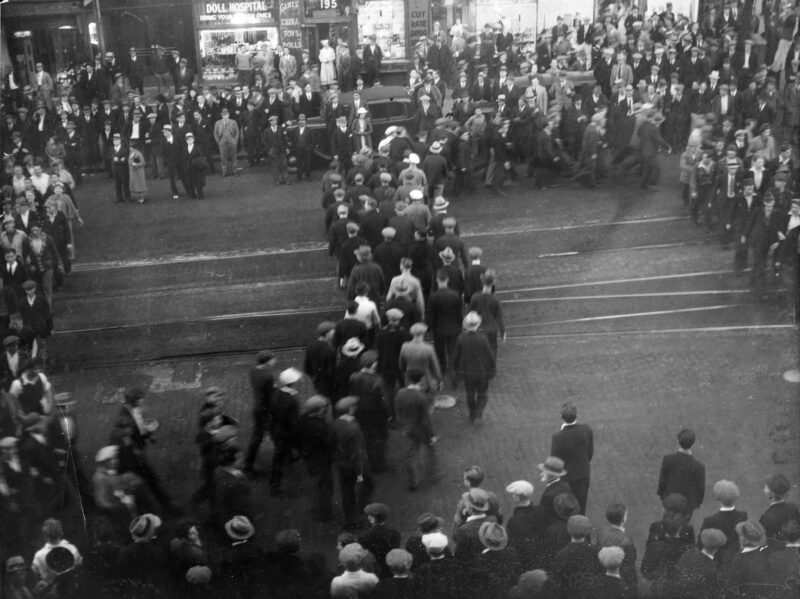 Relief camp men and their supporters parade up Hastings Street to cheer men occupying the top floor of the Public Library and City Museum (now Carnegie Centre), 1935. Photo filed May 20, 1935. "Snake parades" were frequent during the time relief camp strikers spent in Vancouver.