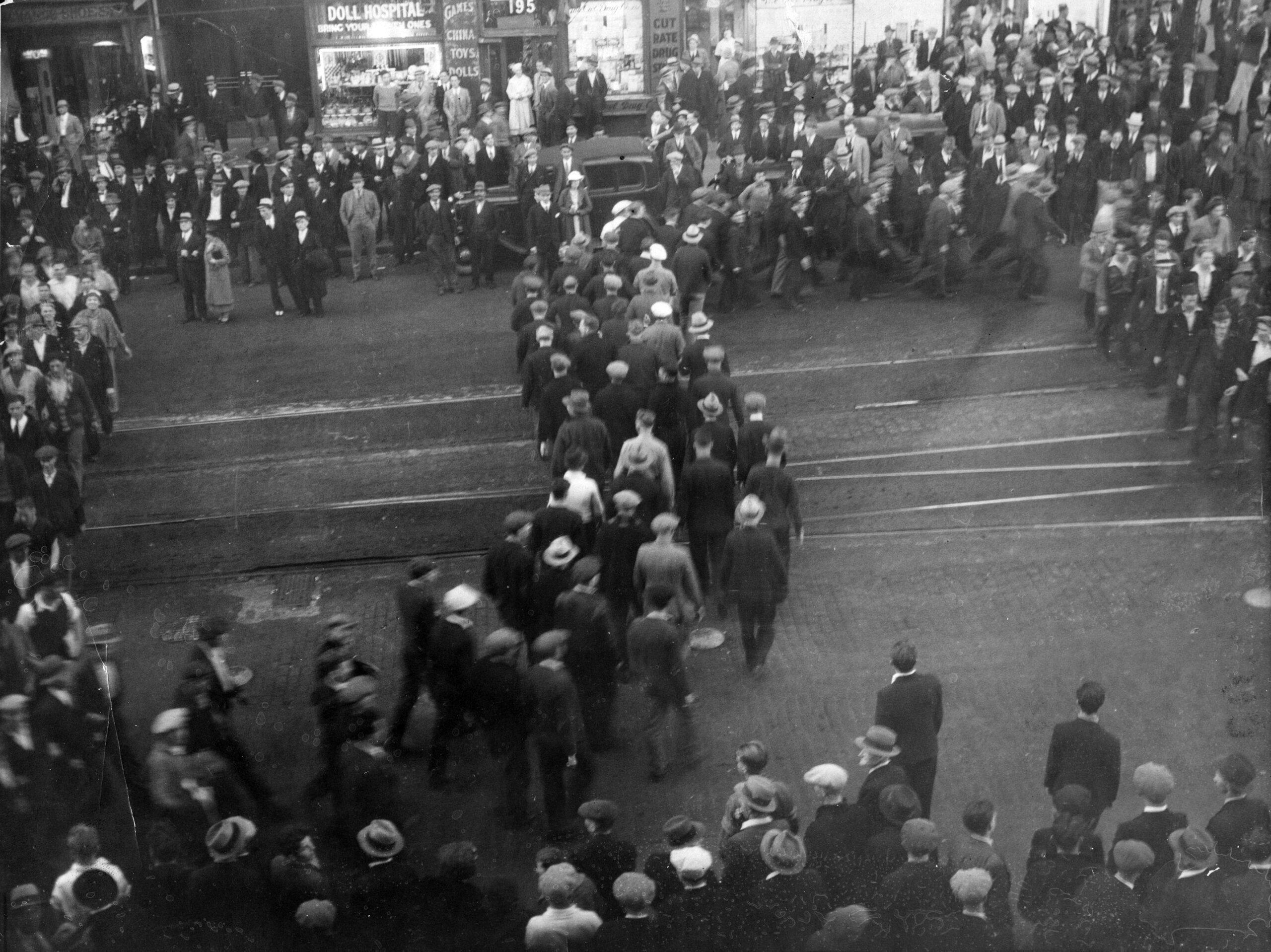 Relief camp men and their supporters parade up Hastings Street to cheer men occupying the top floor of the Public Library and City Museum (now Carnegie Centre), 1935. Photo filed May 20, 1935. "Snake parades" were frequent during the time relief camp strikers spent in Vancouver.